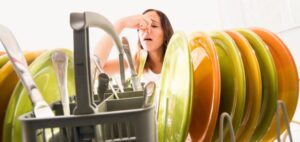 woman-holding-her-nose-over-smelly-dishwasher